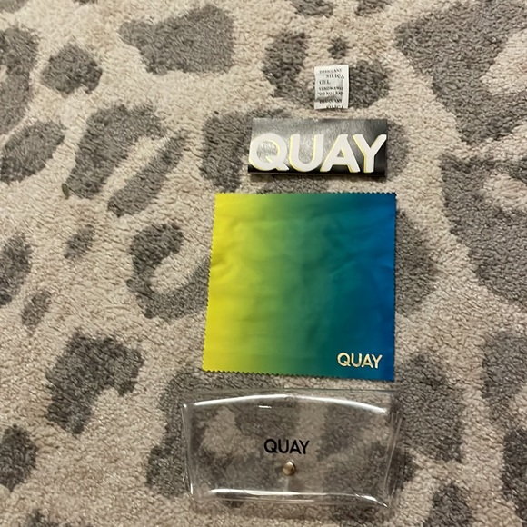 Clear QUAY sunglasses case with blue, green, and yellow cleaner - Picture 2 of 5